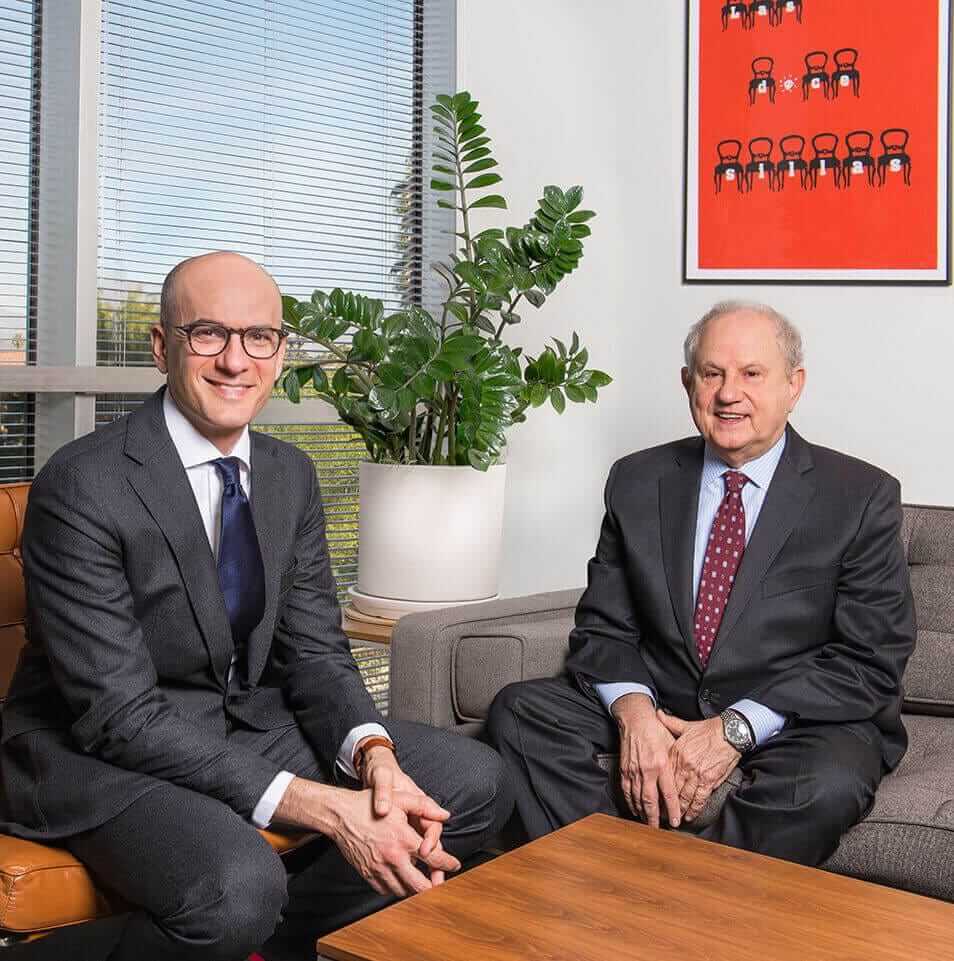 Two attorneys from Cohen Law Partners sitting in an office
